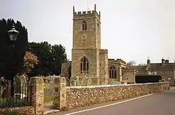 Stone building with square tower.