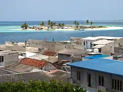 The island of Kandholhudhoo (foreground) that was completely destroyed by the tsunami of 2004. Residents took temporary residence in other nearby islands including Bandaveri island (background)