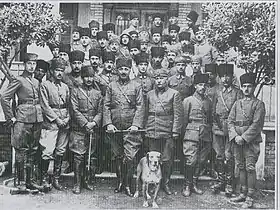 Large group photo, with a dog in front