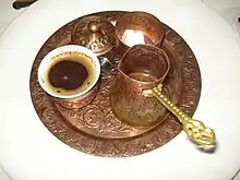 Turkish coffee set containing a cup of coffee, a cezve and a sugar bowl