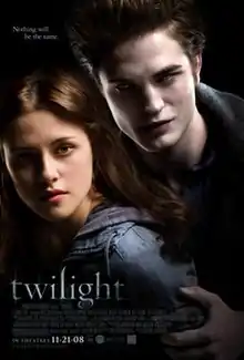 A pale young man fills the top right of the poster, hovering over a brown-haired young woman on the left, with the word "twilight" on the lower left.