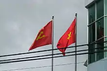 The national flag beside the flag of the Communist Party of Vietnam