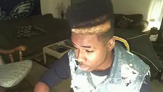 Image 129American teenager with hi-top fade and distressed acid wash denim vest (from 2010s in fashion)