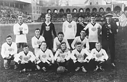 Formal team photo on the pitch, with a small American flag