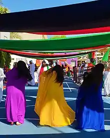 Image 14An Emirati folk dance, the women flip their hair sideways in brightly coloured traditional dress. (from Culture of the United Arab Emirates)