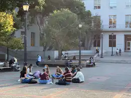 2021: Safety first: Students protecting students by wearing face masks while they hang out outdoors in small group settings.