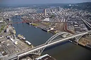 The deck of the Fremont Bridge goes through the arch, the central span is suspended from and ties the arch, while the side spans of the deck are supported.