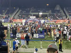 Celebrations taking place with the winning team receiving the trophy on the championship podium.