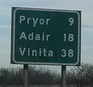 A highway distance sign in Oklahoma using button copy