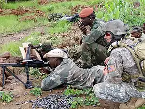 A United States special forces NCO watches weapons marksmanship training for a member of a Malian counter-terrorism unit in December 2010.