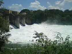 Left-bank view of the dam, with all four spillways open.