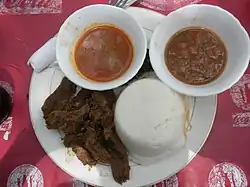 Image 14Ugali, served here with beef and sauce, is a mainstay of the cuisine throughout the African Great Lakes region. (from Culture of Kenya)