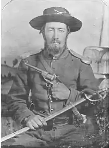 A US Civil war soldier Cavalry [North] with sabre and Lefaucheux pistol; he wears shoulder scales as part of his dress uniform.