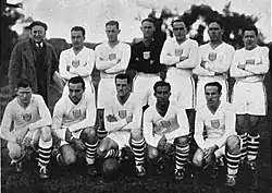 Another team photo; some members are kneeling, and others are standing.