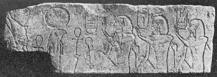 Relief showing three kings looking right, with hieroglyphs around their heads