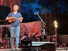 Vance Joy playing live music.