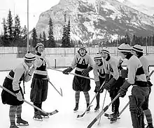 women's hockey team posing for a picture on the ice