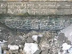 Vermiculate ashlar stonework on the abutment of the bridge at water level