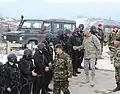 LTG Mark P. Hertling, U.S. Army Europe Commander, congratulates Macedonian troops following a training demonstration in Macedonia.