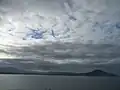 View of the Karitane harbour and seaside on a dark and cloudy day