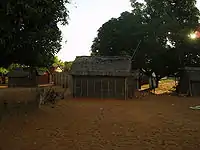 Small one-room rectangular house with walls made of twigs packed with earth