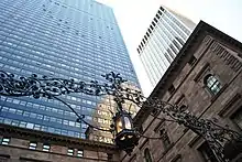 Looking up at the Palace Hotel's skyscraper from ground level, with the Villard Houses in the foreground