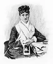 A middle-aged woman wearing her hair up on her head, wearing a dark dress with a large white collar