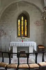 Choir with two consecration crosses painted on the wall.