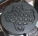 A waffle iron in the shape of Texas, commonly found at motels in the state