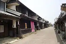 Wooden houses with white walls, roof tiles and protruding walls.