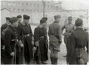 IPN copy #42Askaris assigned to the operationStroop and foreign fighters at the Umschlagplatz, with Stawki 5/7 in the back.