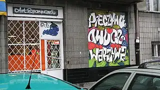 Graffiti as legal advertising on a grocer's shop window in Warsaw, Poland