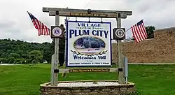 Sign welcoming visitors to Plum City.