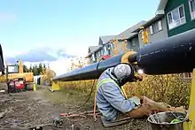 A skilled worker welding a pipe in British Columbia, Canada, in 2014