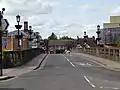 The approach to the bridge from the south at Mardol Quay in June 2021. Note the temporary signs instructing pedestrians to walk on the left pavement to aid social distancing during the COVID-19 pandemic.