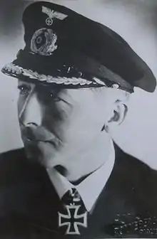 A black and white photo of a man wearing a military uniform with an Iron Cross.