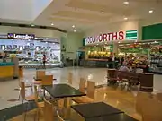 The entrance to the Woolworths supermarket in the Fresh Food Market. Since then, the Woolworths and surrounding area has been refurbished.