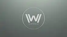 The letter "W" inside a circle as white text on a grey background.