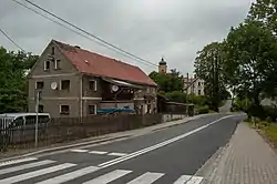 Road with a house and church in the distance