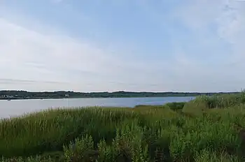 Winnapaug Pond (also known as Brightman Pond) is a breached saltwater pond in Westerly, Rhode Island, United States, connected to Block Island Sound by the Weekapaug Breachway, which was constructed during the mid-1950s. The 2.5-mile (4.0 km) long lake is separated from the Atlantic by a large sandbar.