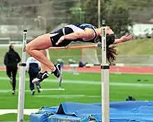 Image 22A woman attempting to high jump whilst using the Fosbury Flop technique (from Track and field)