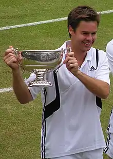 Image 23Todd Woodbridge holding the Gentlemen's doubles silver challenge cup in 2004 (from Wimbledon Championships)