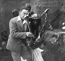 Leonard Woolley holding the hardened plaster mold of the Sumerian Queen's Lyre, 1922