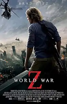 Brad Pitt standing on a rooftop, his back to the viewer, and a gun strapped over his shoulder. He is looking out over a devastated city. A helicopter flies overhead nearby.