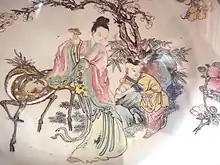 Xi Wangmu on a Qing dynasty porcelain plate, beneath a flowering prunus tree