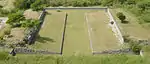 One of the ballcourts at Xochicalco. Note the characteristic -shape, as well as the rings set above the apron at center court. The setting sun of the equinox shines through the ring.