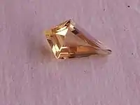 Yellow topaz in stepped kite-shaped cut