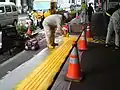 Installation of tactile paving on sidewalk