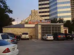 Photograph of a building's exterior from a parking lot