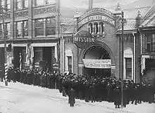 Black and white photo of many men in queue for food at the Yonge Street Mission